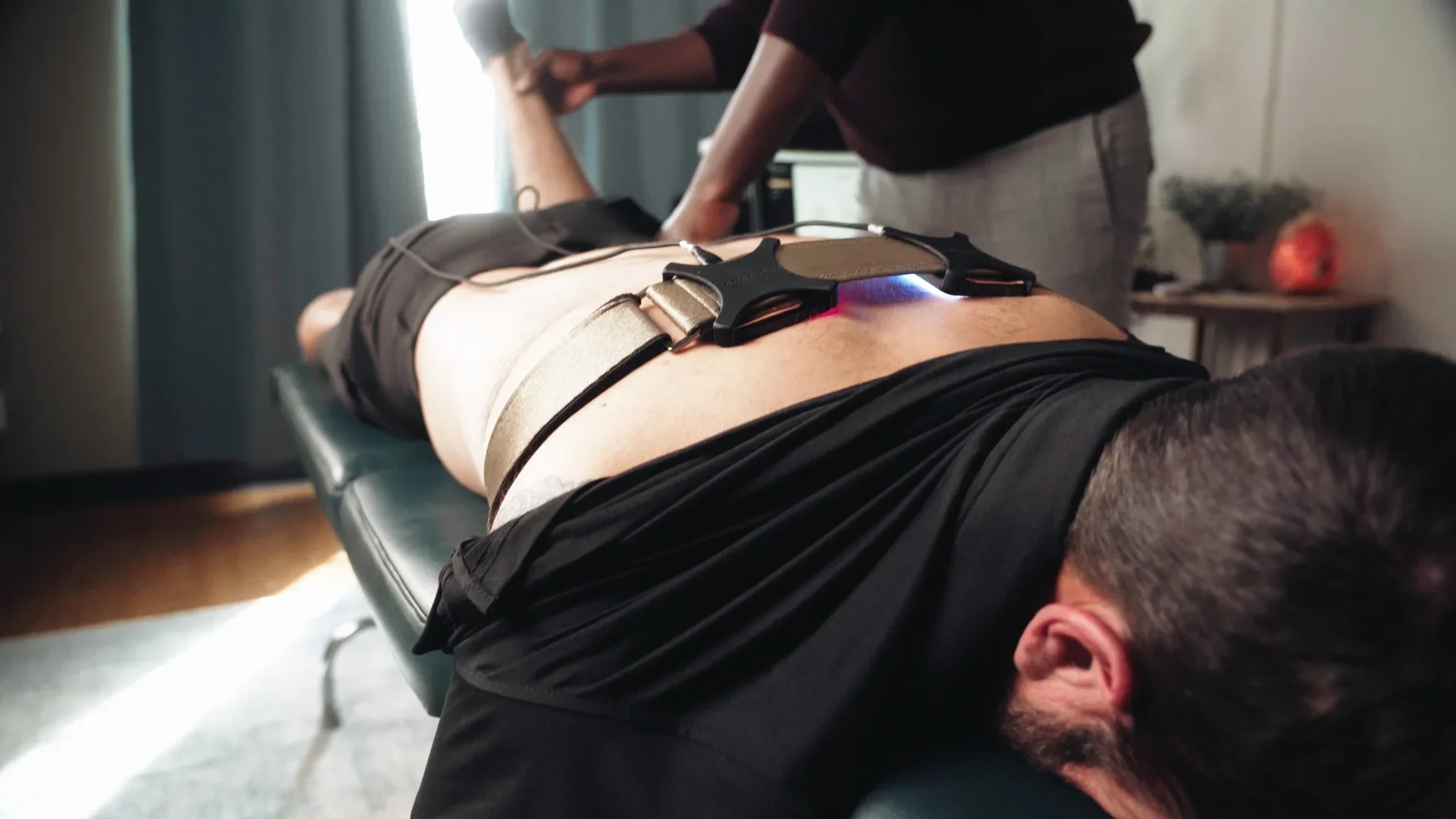 Tired physical therapist relieved by digital health tools using wearable mobility device in clinic