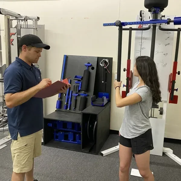 therapist assisting patient with circular resistance therapy using Twist Resist system in modern rehabilitation center